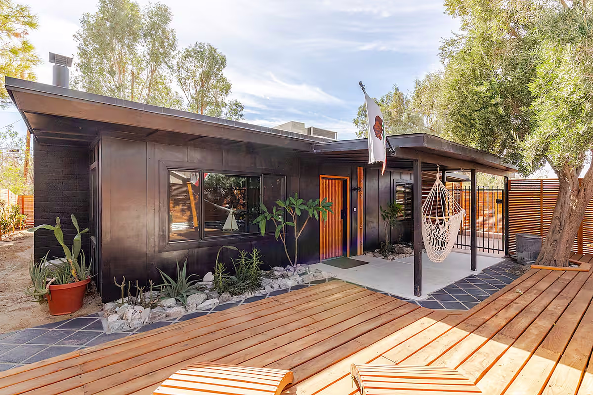 Dark exterior with orange wood front door